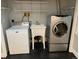 Laundry room with modern washer, dryer, utility sink and shelving units at 7565 S Cove Cir, Centennial, CO 80122