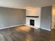 Spacious living room with a white-painted brick fireplace and modern hardwood flooring at 7565 S Cove Cir, Centennial, CO 80122