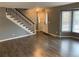 Inviting living area with a staircase and natural light streaming through the window at 7565 S Cove Cir, Centennial, CO 80122