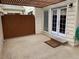 Paver patio features decorative pergola covering, privacy fence, and double glass doors to the home at 7565 S Cove Cir, Centennial, CO 80122