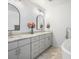 Bright bathroom featuring a double vanity, marble floors, modern fixtures, and a luxurious soaking tub at 810 Jasmine St, Denver, CO 80220