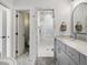 Bright bathroom featuring a marble shower and a double vanity with modern fixtures at 810 Jasmine St, Denver, CO 80220
