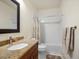 Bathroom featuring a granite vanity top, subway tile and shower-tub combo at 810 Jasmine St, Denver, CO 80220