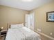 Bright bedroom features neutral walls and carpet, complemented by a comfortable bed with patterned linens at 810 Jasmine St, Denver, CO 80220