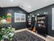 Bedroom featuring dark gray walls, vaulted ceilings and large bookshelves at 810 Jasmine St, Denver, CO 80220