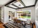 Dining room with table, chairs, rug, contemporary light fixture, and sliding glass doors to outdoor patio at 810 Jasmine St, Denver, CO 80220
