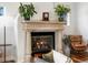 Elegant stone fireplace with gas logs, flanked by plants, creating a cozy and inviting atmosphere at 810 Jasmine St, Denver, CO 80220