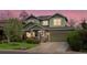 Charming two-story home with a well-manicured lawn, stone accents, and attached two car garage at 810 Jasmine St, Denver, CO 80220