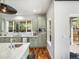 Modern kitchen with stainless steel appliances, marble countertops, an island, and seating for four at 810 Jasmine St, Denver, CO 80220