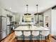 Bright and modern kitchen with stainless steel appliances, an island with bar seating and marble countertops at 810 Jasmine St, Denver, CO 80220