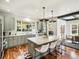 Bright and modern kitchen with stainless steel appliances, an island with bar seating and marble countertops at 810 Jasmine St, Denver, CO 80220