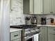 Close-up of kitchen featuring range with marble backsplash and stainless steel appliances at 810 Jasmine St, Denver, CO 80220
