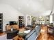 Open-concept living room flows to kitchen, featuring hardwood floors, modern decor, and plenty of natural light at 810 Jasmine St, Denver, CO 80220
