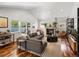 Open living room with hardwood floors, gas fireplace, recessed lights, and view to outside at 810 Jasmine St, Denver, CO 80220