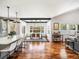 Open concept kitchen and dining area with hardwood floors and modern pendant lighting at 810 Jasmine St, Denver, CO 80220