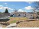 This backyard has grass, a shed, a trampoline, and a covered porch at 1049 Lilac St, Broomfield, CO 80020