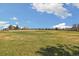 Large grassy baseball field on a sunny day with trees in the background at 1049 Lilac St, Broomfield, CO 80020