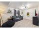 Finished basement with cozy seating, neutral paint, modern light fixture and tile floors at 1049 Lilac St, Broomfield, CO 80020