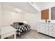 This cozy bedroom has a black-and-white theme, a desk, dresser and hardwood floors at 1049 Lilac St, Broomfield, CO 80020
