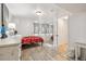 This bedroom features a red bed, white walls, wood floors and a sliding-door closet at 1049 Lilac St, Broomfield, CO 80020