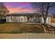 Inviting home with manicured lawn, rock landscaping, updated windows, and a welcoming front entrance at 1049 Lilac St, Broomfield, CO 80020