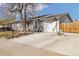 Charming gray single-story home with a well-maintained front yard, concrete driveway, and an attached garage at 1049 Lilac St, Broomfield, CO 80020