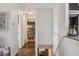 Hallway view with hardwood floors leading to a living space with ample natural light at 1049 Lilac St, Broomfield, CO 80020