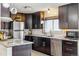 Stylish kitchen with stainless steel appliances, granite countertops, ample dark wood cabinetry, and modern fixtures at 1049 Lilac St, Broomfield, CO 80020