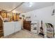 This unfinished laundry room has a washer, dryer, ironing board, and storage shelves at 1049 Lilac St, Broomfield, CO 80020
