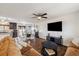 Open-concept living room featuring hardwood floors, a ceiling fan, and seamlessly connected to the dining area at 1049 Lilac St, Broomfield, CO 80020