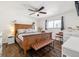 Comfortable main bedroom with hardwood floors, ceiling fan and warm wood furniture at 1049 Lilac St, Broomfield, CO 80020