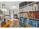 Bright home office boasts natural light, an extensive bookshelf, and wood floors at 1049 Lilac St, Broomfield, CO 80020