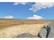Expansive open space featuring a cracked arid field and rolling hills on a bright day at 1049 Lilac St, Broomfield, CO 80020