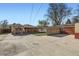 Backyard concrete area with small grass area and detached garage at 2220 Quebec St, Denver, CO 80207
