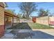 Backyard features grass, trees, a wood fence and a detached garage at 2220 Quebec St, Denver, CO 80207