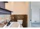 Bathroom featuring stone-style tiled wainscoting, a sink, and a toilet at 2220 Quebec St, Denver, CO 80207