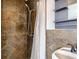 Bathroom featuring a shower with stone-style tiling and modern fixtures at 2220 Quebec St, Denver, CO 80207