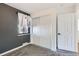 Bedroom featuring neutral carpet, window with curtains, and a double door closet at 2220 Quebec St, Denver, CO 80207