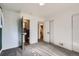 A carpeted bedroom with white walls showing access to two bathrooms and closet at 2220 Quebec St, Denver, CO 80207