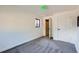 Bedroom with neutral walls and carpeting, showing two windows and a closet at 2220 Quebec St, Denver, CO 80207