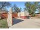 Detached garage in backyard with brick and siding exterior at 2220 Quebec St, Denver, CO 80207
