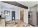 An open concept kitchen features stainless steel appliances and unique stone tile flooring at 2220 Quebec St, Denver, CO 80207