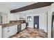 A kitchen with white cabinets, stainless steel appliances, and unique stone tile flooring at 2220 Quebec St, Denver, CO 80207