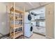 Laundry room featuring stacked washer and dryer with view of adjacent kitchen at 2220 Quebec St, Denver, CO 80207