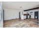 Open-concept living area with wood-look floors, white walls and views of the kitchen at 2220 Quebec St, Denver, CO 80207