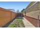 Side yard with a wood fence and tool shed at 2220 Quebec St, Denver, CO 80207