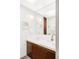 Bathroom featuring a large mirror, vanity with wood cabinets, and bright lighting at 7170 W 8Th Pl, Lakewood, CO 80214
