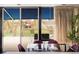 Bright dining area with deck access, glass table, purple chairs, and outdoor views at 7170 W 8Th Pl, Lakewood, CO 80214