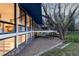 Unique contemporary home with floor-to-ceiling windows, outdoor deck, and blue awnings provides abundant natural light at 7170 W 8Th Pl, Lakewood, CO 80214