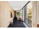 Bright hallway featuring floor-to-ceiling windows and wood paneling for a modern and welcoming entry at 7170 W 8Th Pl, Lakewood, CO 80214